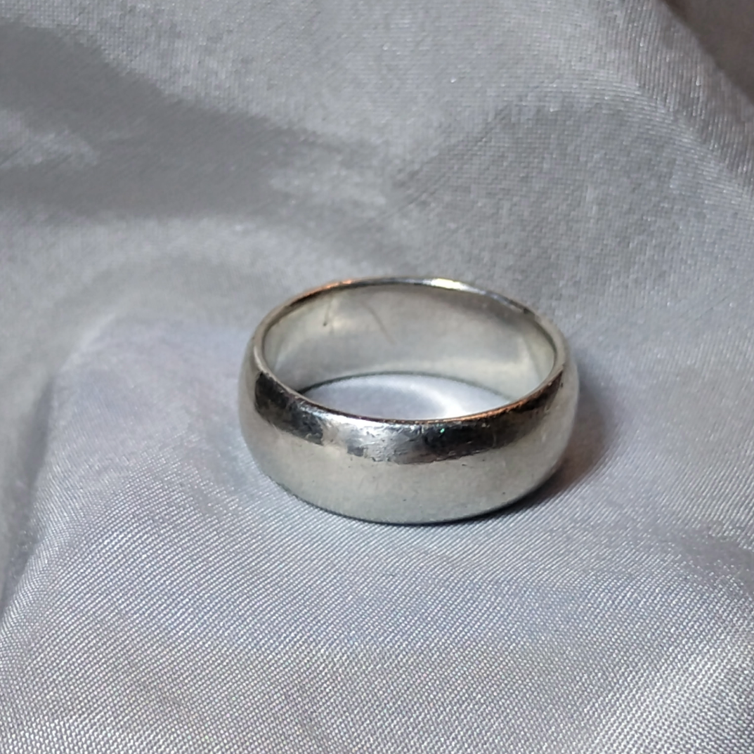 Close up shot of a vintage wide band silver ring, size 6, from Violet Dreamer.