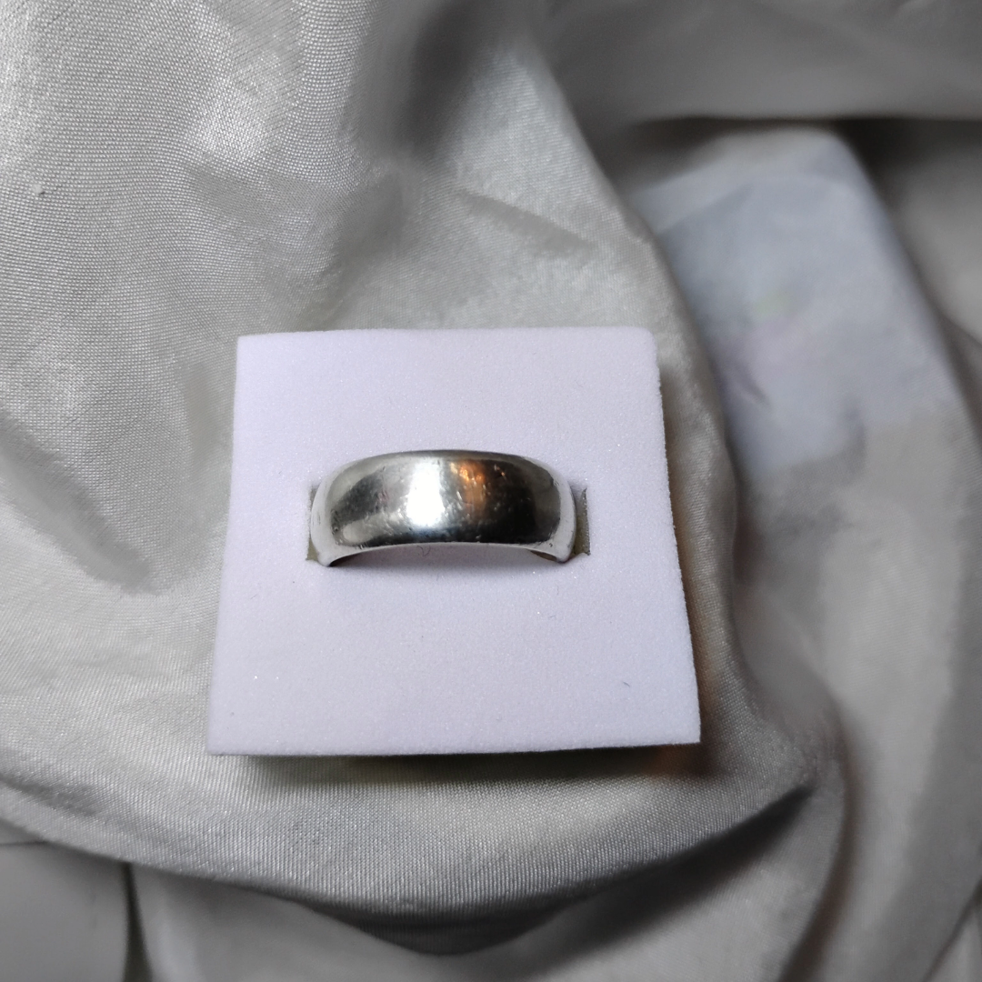 Close up shot of a vintage wide band silver ring, size 6, from Violet Dreamer.