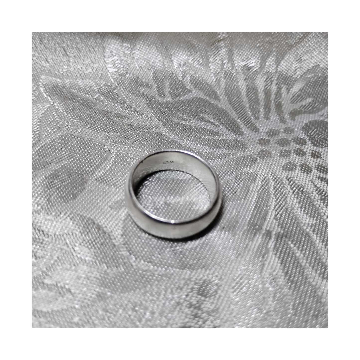 View of markings inside a vintage wide band silver ring, size 6 from Violet Dreamer.