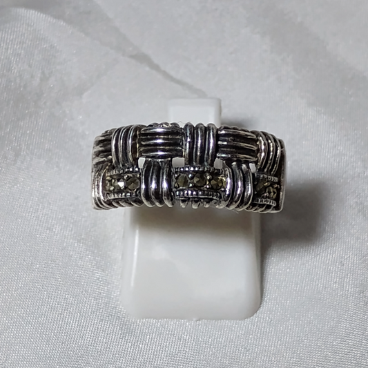 Silver ring featuring an intricate woven and textured pattern with oxidized detailing, accented with marcasite stones for added sparkle.