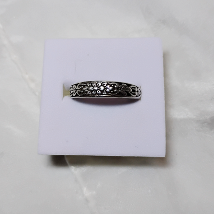 Antique sterling silver Art Nouveau ring with intricate floral and vine motifs in a classic, handcrafted design.
