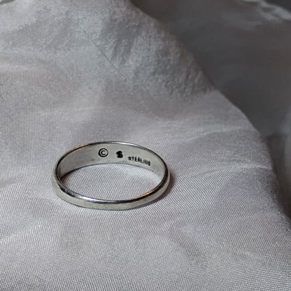 Antique sterling silver Art Nouveau ring with intricate floral and vine motifs in a classic, handcrafted design.
