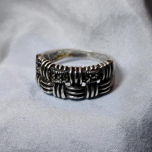 Silver ring featuring an intricate woven and textured pattern with oxidized detailing, accented with marcasite stones for added sparkle.