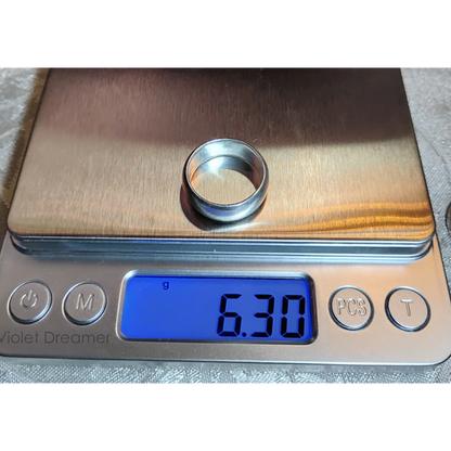 A vintage, wide band silver ring, size 6, sitting on a digital scale, with a reading of 6.3g from Violet Dreamer.